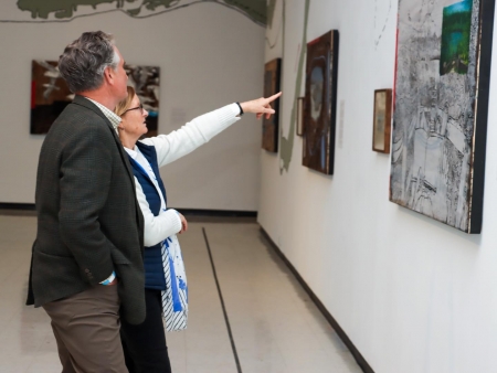 People looking at art on the wall